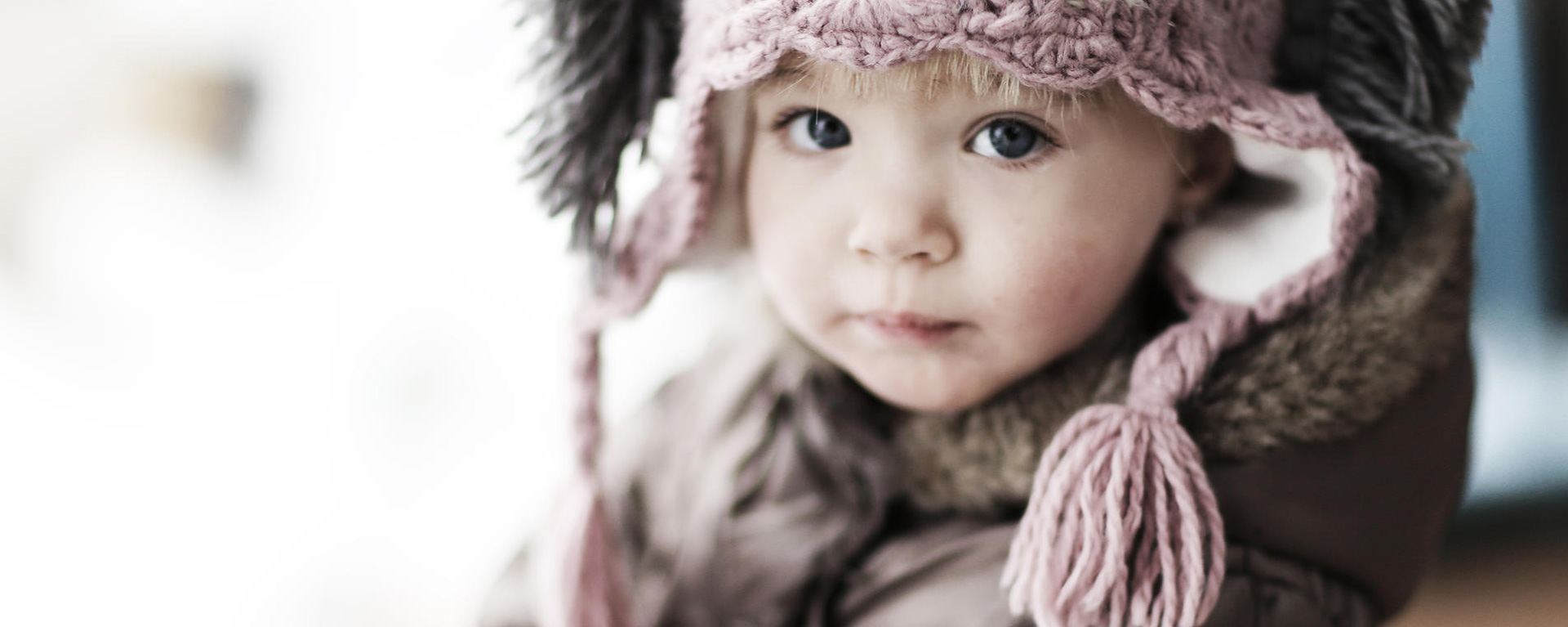 Photograph of a child in a knitted hat